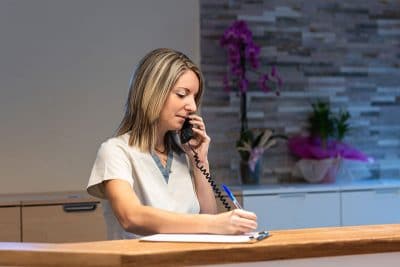 Woman Answering Phones at a dental practice