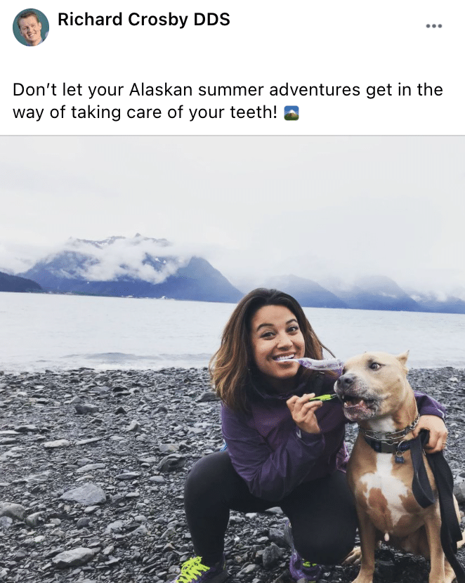 attractive young woman enjoying the Alaskan view with her dog