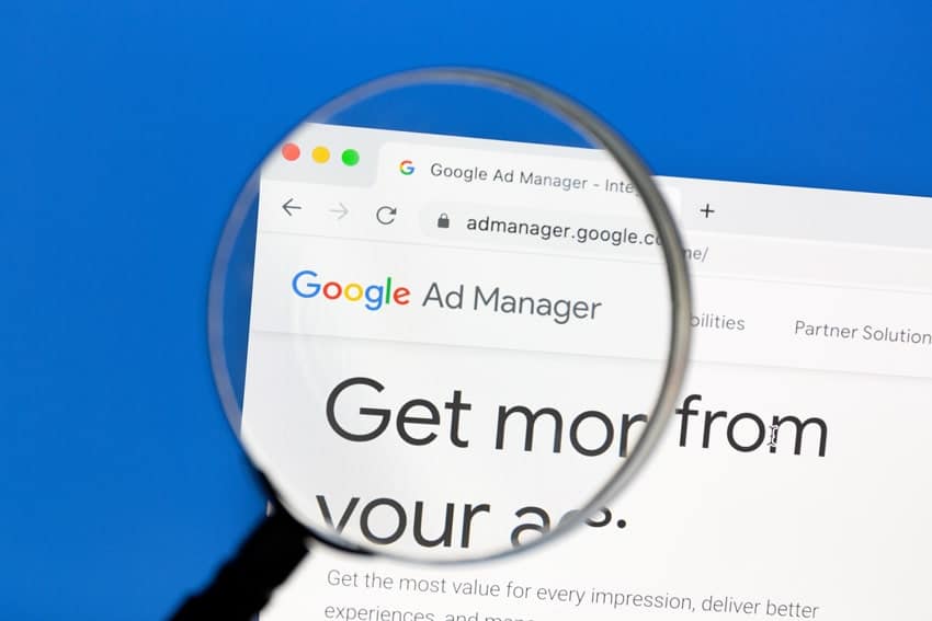 a magnify glass over a screenshot of google ad manager